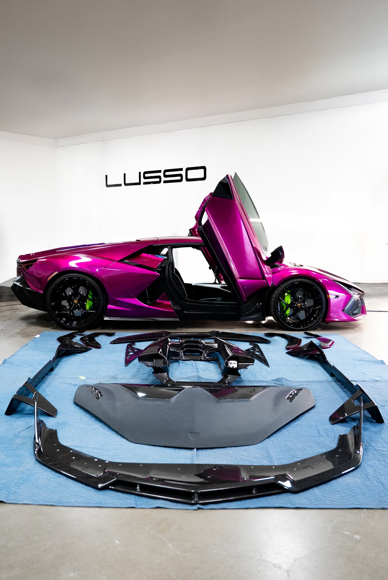 Pink Lamborghini Revuelto with a carbon aero kit laid out, photographed at Lusso Auto Design
