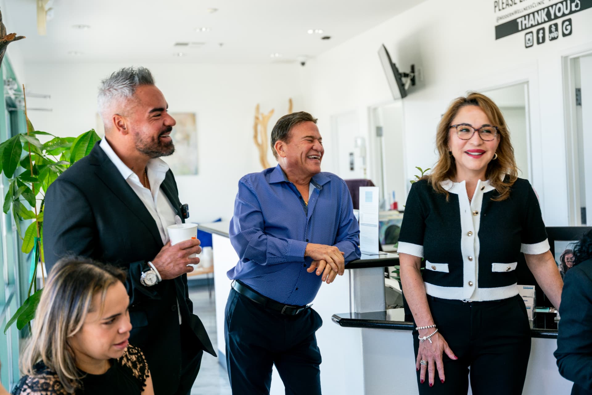 Modern Wellness Clinic team laughing at reception
