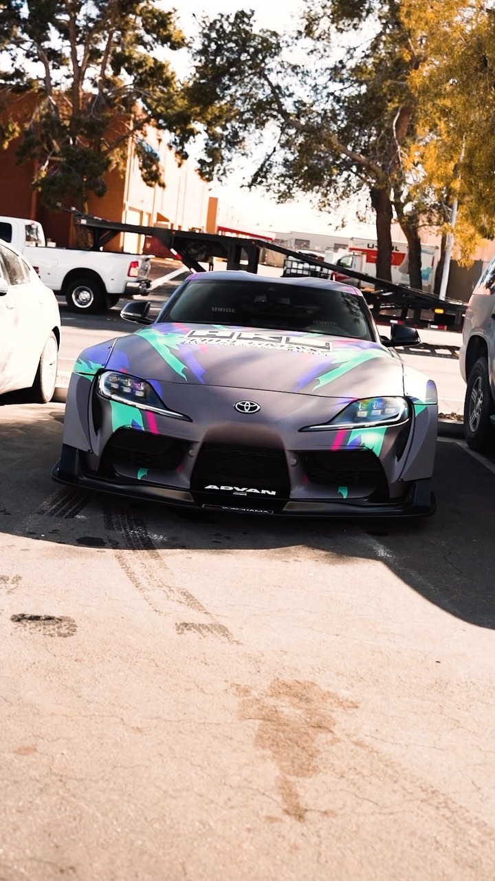 Widebody Toyota Supra with an iridescent wrap parked in a Las Vegas industrial lot