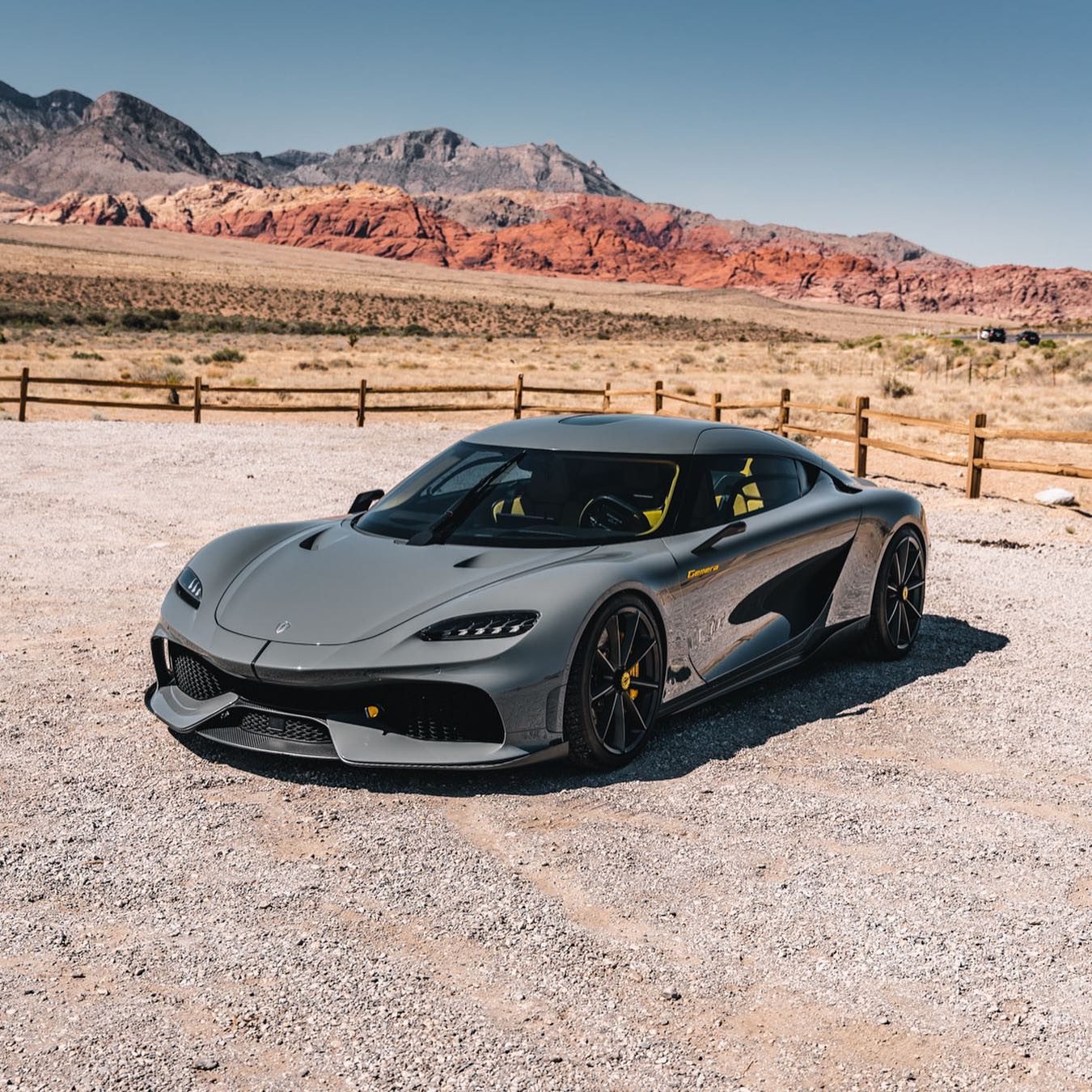 Koenigsegg Gemera parked in the desert with the red rock formations outside Las Vegas behind it